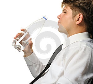 The businessman drinking water from a bottle