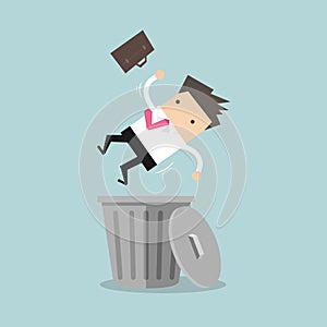 Businessman dropped into trashcan layoff concept.