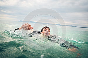 Businessman Drowning in the Sea