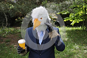 Businessman with an eagle face making a phone call