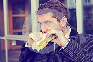 Businessman is eating bread