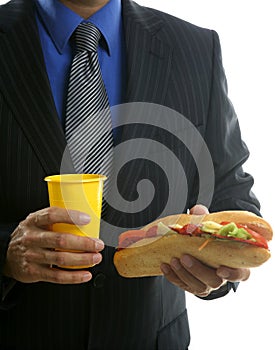 Businessman eating junk fast food