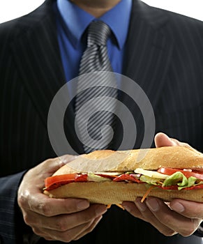 Businessman eating junk fast food