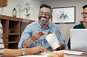 Businessman eating noodles during lunch break