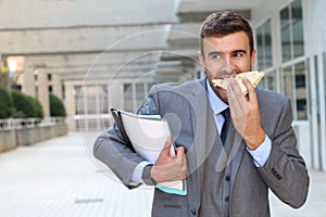 Businessman eating a sandwich on the go