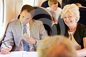 Businessman Eating Sandwich On Train Journey