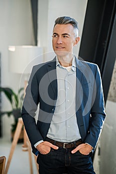 Businessman in an elegant suit looking confident and contented photo