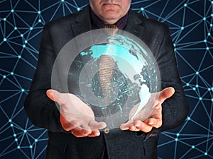 Businessman embracing holographic display of Globe grid with infographic elements