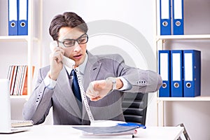 The businessman employee talking on the office phone