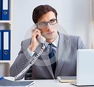 Businessman employee talking on the office phone