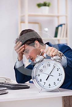 Businessman employee in urgency and deadline concept with alarm