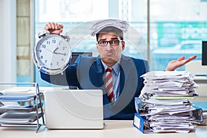 Businessman employee in urgency and deadline concept with alarm