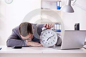 Businessman employee in urgency and deadline concept with alarm