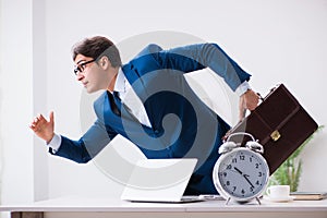 Businessman employee in urgency and deadline concept with alarm