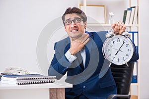 Businessman employee in urgency and deadline concept with alarm