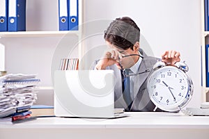 Businessman employee in urgency and deadline concept with alarm