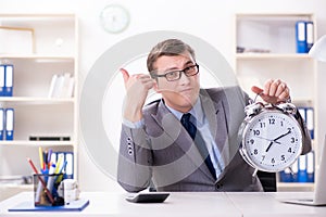 Businessman employee in urgency and deadline concept with alarm