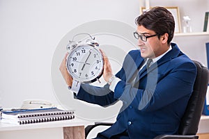 Businessman employee in urgency and deadline concept with alarm