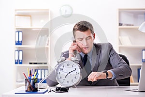 Businessman employee in urgency and deadline concept with alarm