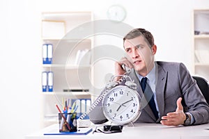 Businessman employee in urgency and deadline concept with alarm