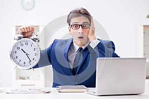 Businessman employee in urgency and deadline concept with alarm