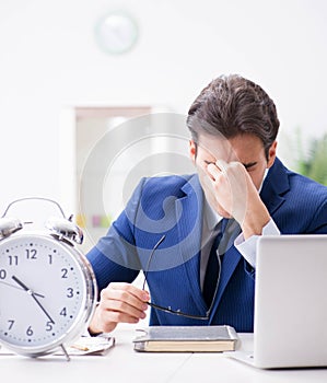 Businessman employee in urgency and deadline concept with alarm