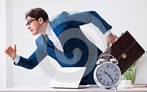 Businessman employee in urgency and deadline concept with alarm