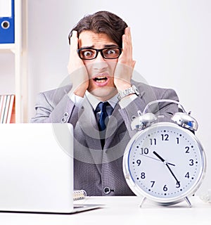 Businessman employee in urgency and deadline concept with alarm