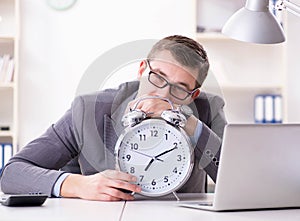 Businessman employee in urgency and deadline concept with alarm