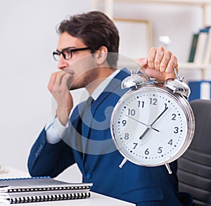 Businessman employee in urgency and deadline concept with alarm