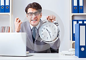 Businessman employee in urgency and deadline concept with alarm