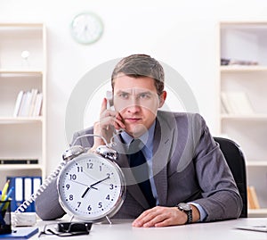 Businessman employee in urgency and deadline concept with alarm