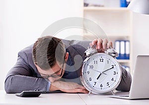 Businessman employee in urgency and deadline concept with alarm