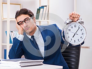 Businessman employee in urgency and deadline concept with alarm