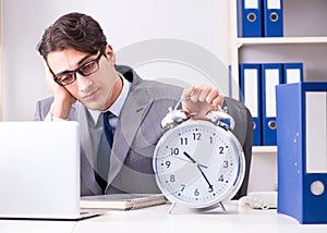 Businessman employee in urgency and deadline concept with alarm