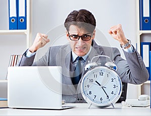 Businessman employee in urgency and deadline concept with alarm