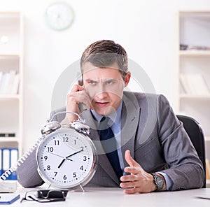 Businessman employee in urgency and deadline concept with alarm