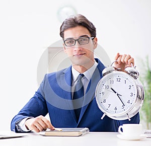 Businessman employee in urgency and deadline concept with alarm