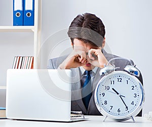 Businessman employee in urgency and deadline concept with alarm