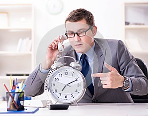 Businessman employee in urgency and deadline concept with alarm