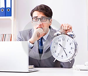 Businessman employee in urgency and deadline concept with alarm