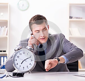 Businessman employee in urgency and deadline concept with alarm