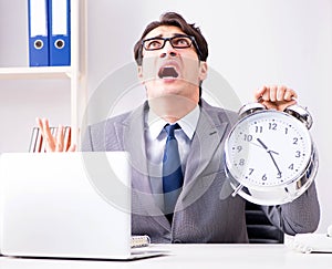 Businessman employee in urgency and deadline concept with alarm