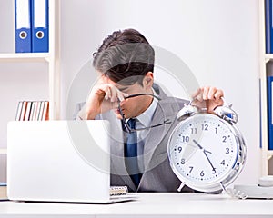 Businessman employee in urgency and deadline concept with alarm