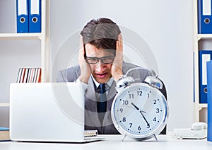 Businessman employee in urgency and deadline concept with alarm