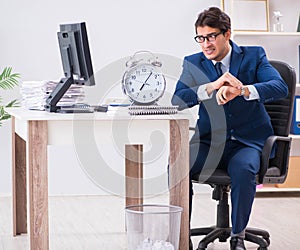 Businessman employee in urgency and deadline concept with alarm