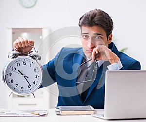 Businessman employee in urgency and deadline concept with alarm