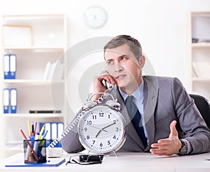 Businessman employee in urgency and deadline concept with alarm