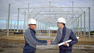 Businessman, engineer, architect, contractor, customer, manager, builder in hard hats having agreement handshake on