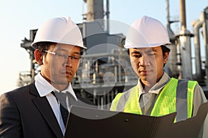 Businessman and engineer oil refinery